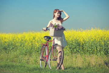 Fototapeta premium Girl on a bike in the countryside