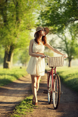 Fototapeta na wymiar Girl on a bike in the countryside