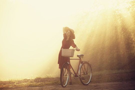 Girl on a bike in the countryside in sunrise time