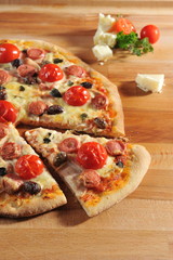 Pepperoni pizza with fresh cherry tomatoes and olives