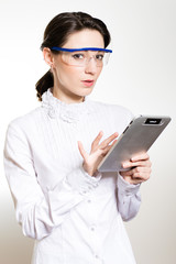 Young business woman using tablet PC and wearing glasses