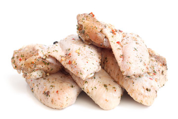Raw chicken wings with condiments