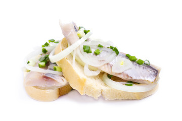 Sandwiches with herring, onions and herbs on white background