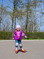 Little girl skating on roller skates