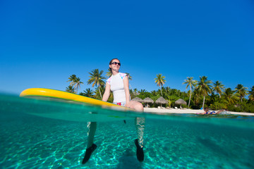 Fototapeta na wymiar Young woman on paddle board