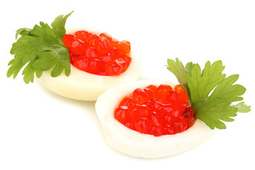 Red caviar in eggs isolated on white