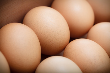 Closeup eggs in wood tray