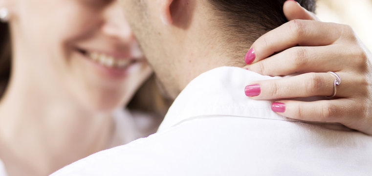 couple just about to kiss - woman's hands with engagement ring