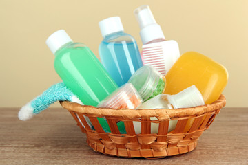 Hotel amenities kit on table on beige background