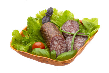 Ripe salami with salad, basil, onion and tomato