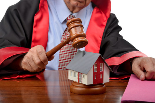 Senior adult judge striking the gavel on house