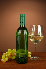 Composition of wine bottle, glass of white wine, grape