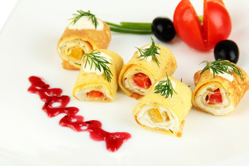 Egg rolls with cheese cream and paprika,on plate, isolated