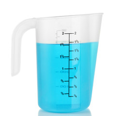 Measuring cup with blue liquid isolated on white