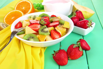 Useful fruit salad of fresh fruits and berries in bowl