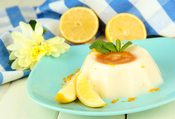 Lemon Panna Cotta with orange zest and caramel sauce,