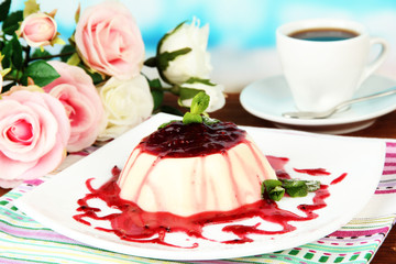 Panna Cotta with raspberry sauce, on bright background