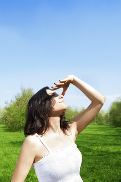 Young woman facing to the sun