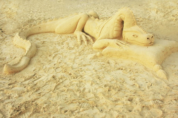 Dragon sand sculpture on a beach