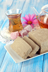 Tasty halva with tea on table