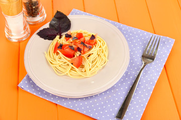 Spaghetti with tomatoes and basil leaves