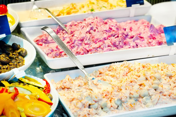 Salads, snacks and appetizers on counter