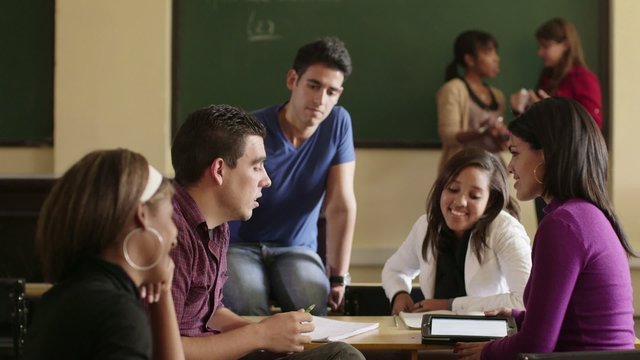School, group of college students talking in classroom