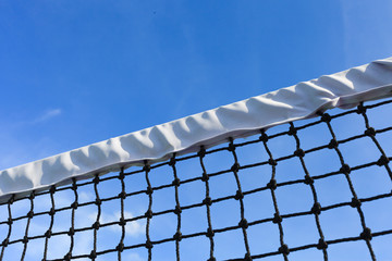 Closeup tennis net with blue sky