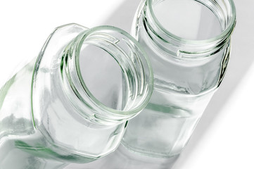 Transparent glass jars on white, with high-key effect