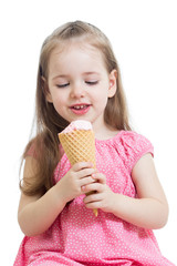 joyful child girl eating ice cream in studio isolated