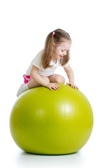Fototapeta na wymiar Kid girl having fun with gymnastic ball isolated