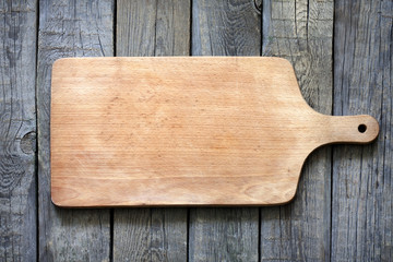 Empty vintage cutting board on planks food background concept