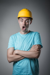 worker in helmet surprised