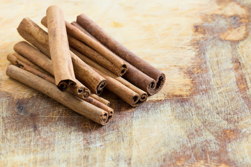 Group of spaces with cinnamon on wooden background