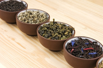 Assortment of dry tea in ceramic bowls