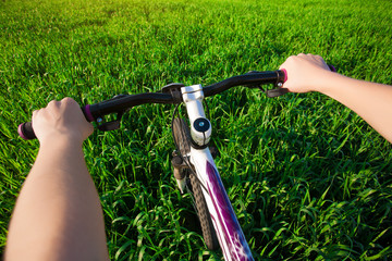 cyclist in a green field on a bike. travel