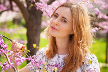 Fototapeta premium Beautiful woman in spring blossom