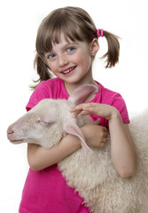 happy little girl with a lamb isolated on a white background © Vera Kuttelvaserova