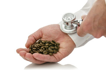 Male hand holding stethoscope on  hand holding coffee grains