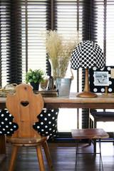 Wooden table and chair with a vintage polka dot lamp