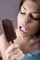 Sexy brunette woman licking chocolate Ice Cream