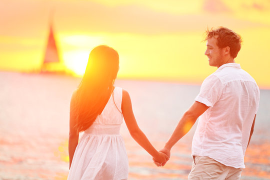 Couple in love happy at romantic beach sunset