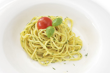 Italian spaghetti pasta with tomato and basil in white dish