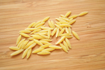 Risoni Pasta on a Wood Background