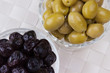 Black and green olives in bowls as appetizers