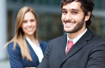 Two business people outdoor smiling