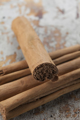 Cinnamon scrolls on a distressed wood background.