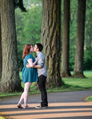 Loving young couple kissing in the park