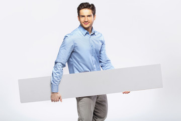Picture of handsome man in suit with a blank board
