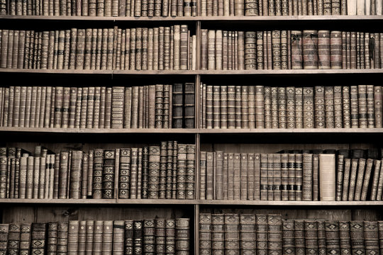 Old books in a library - sepia image
